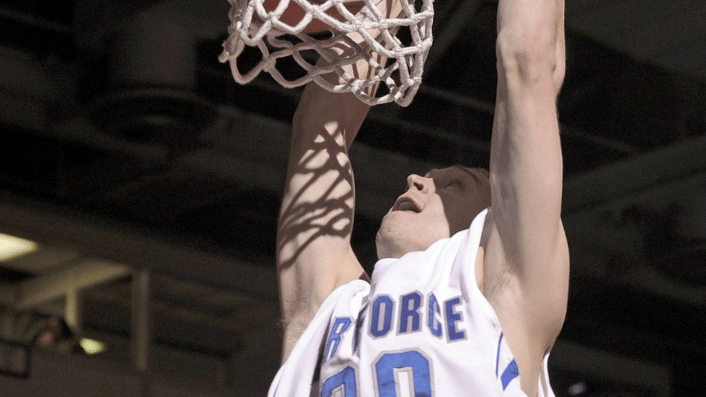 a basketball player dunking the ball during a game