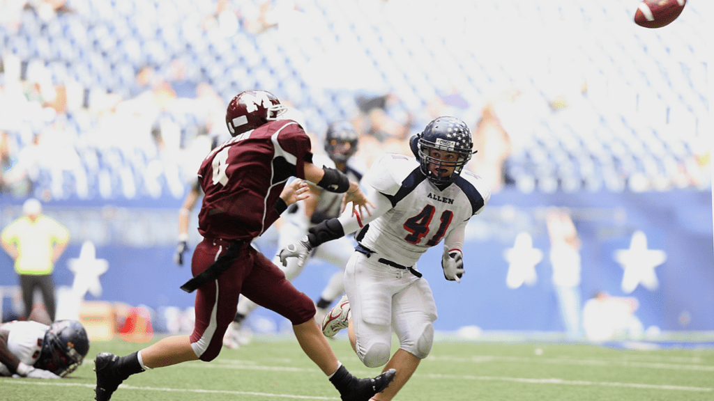 a football player is trying to catch the ball