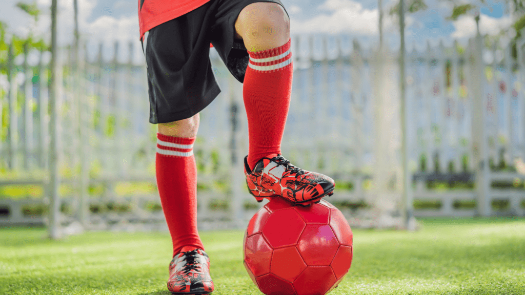 a person is standing on top of a soccer ball