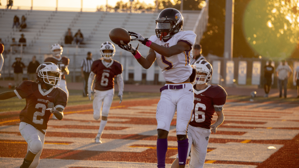 a football player catches the ball during a game