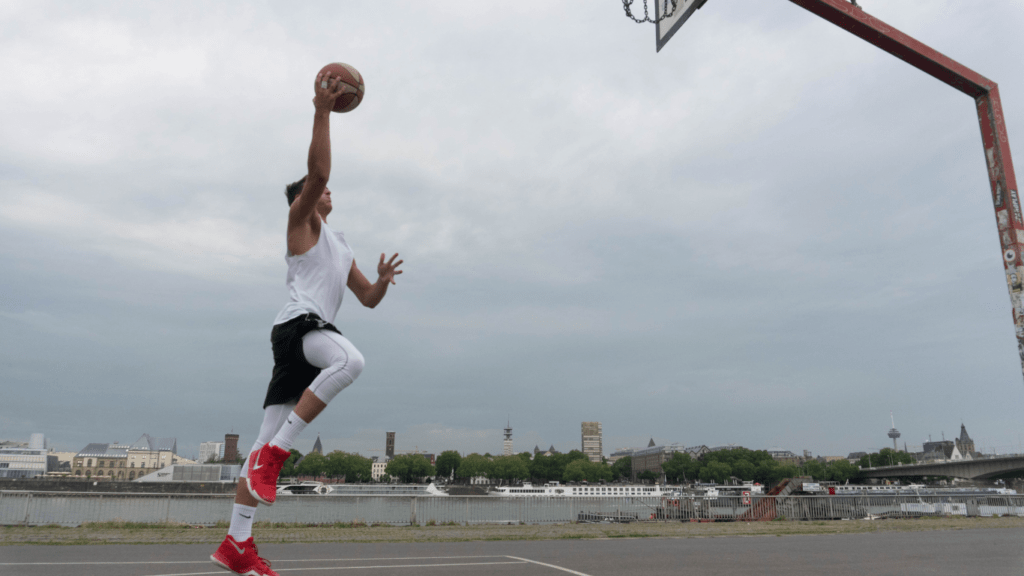 a person is jumping up to dunk a basketball