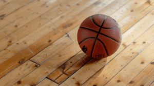 a basketball sits on the floor of a basketball court