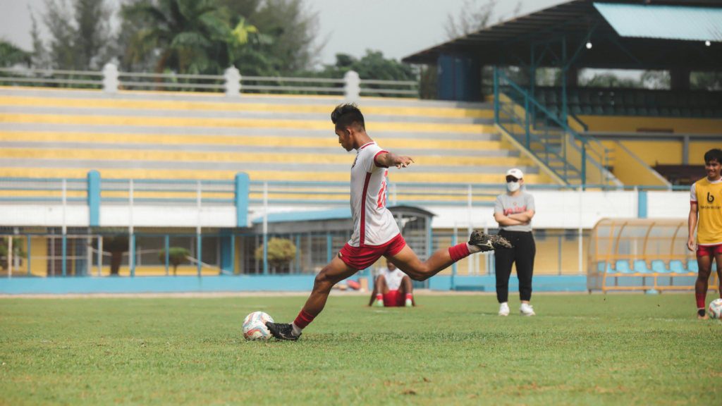 a person kicking a soccer ball