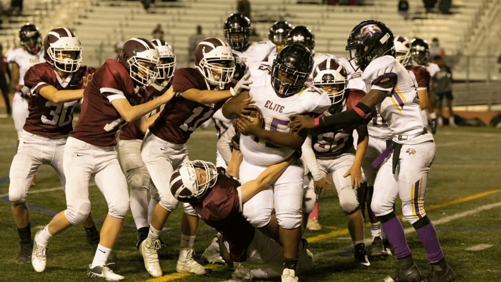 a group of football players on the field during a game