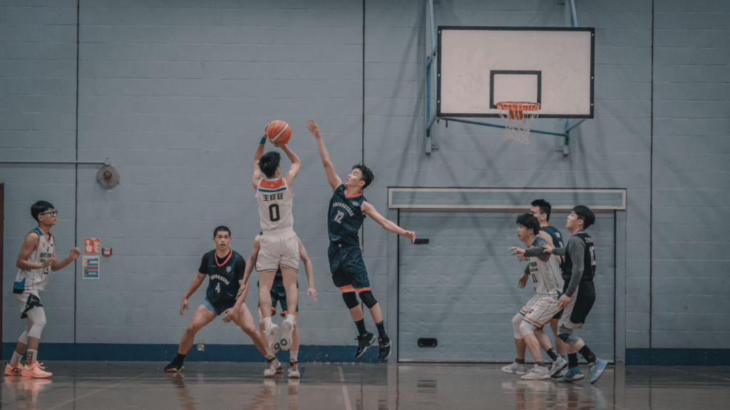 a group of people playing basketball