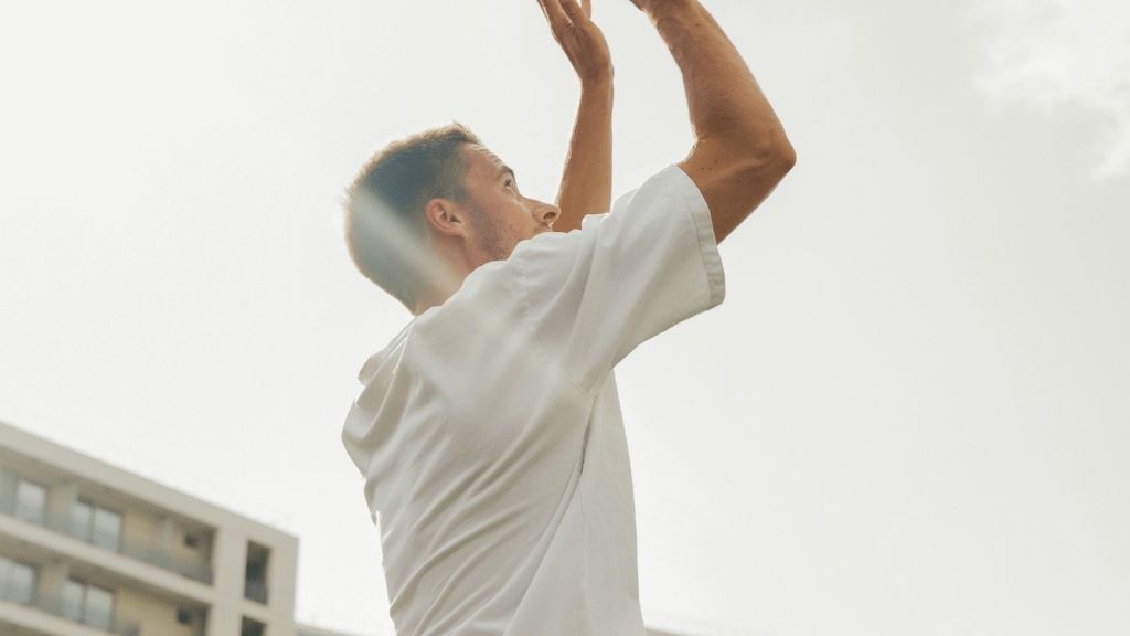 a person is playing basketball on an outdoor court