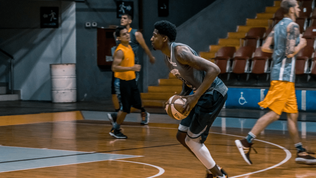 a group of people playing basketball on an indoor court