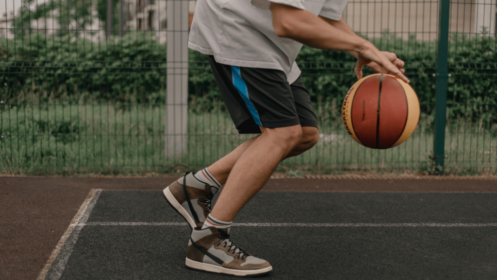 a person holding a basketball on a basketball court