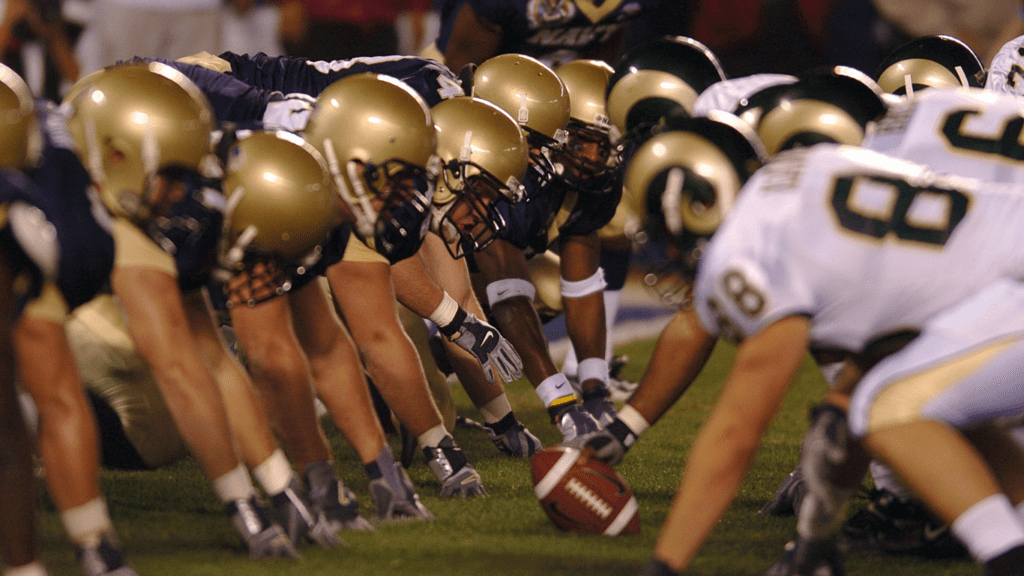 a group of football players are lined up on the field