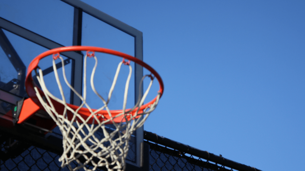 a basketball hoop is seen in front of a blue sky