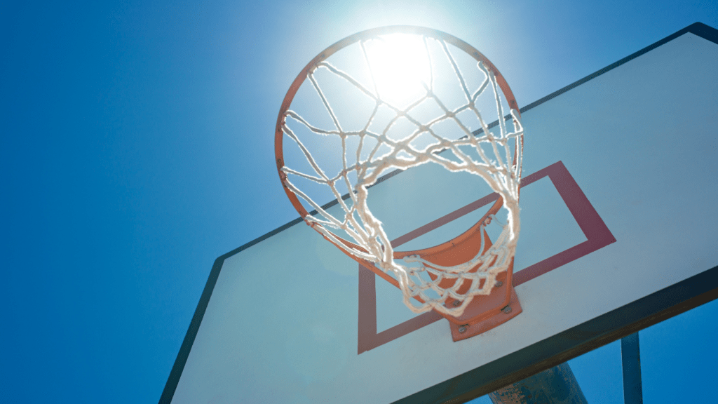 a basketball hoop is seen in front of a blue sky