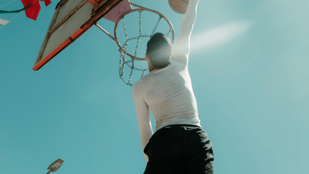 a basketball player in mid air with the ball in his hand