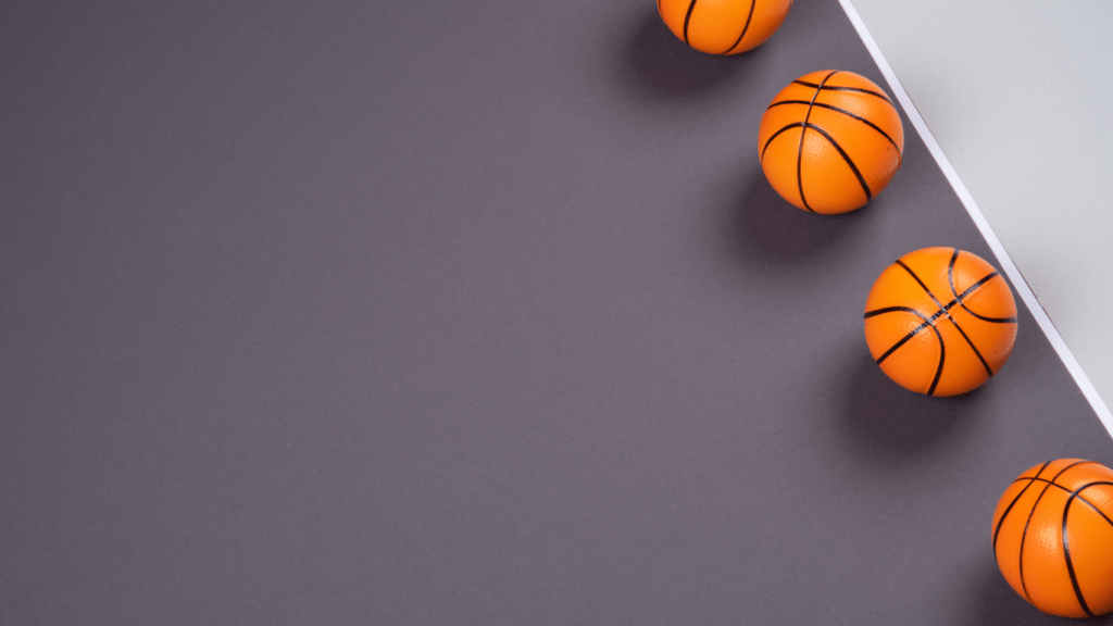 a basketball sits on the floor of a basketball court