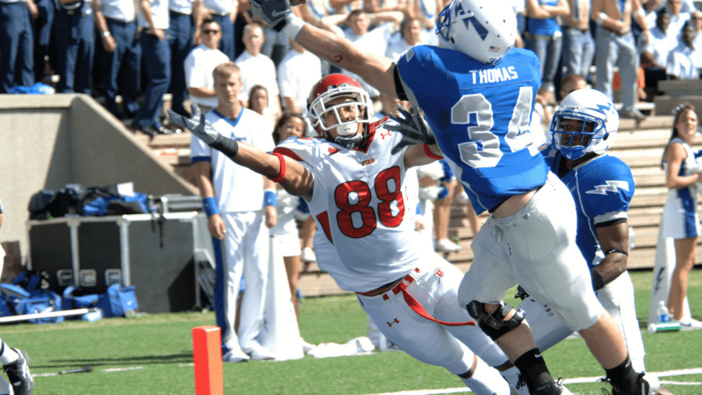 a football player diving for the ball during a game