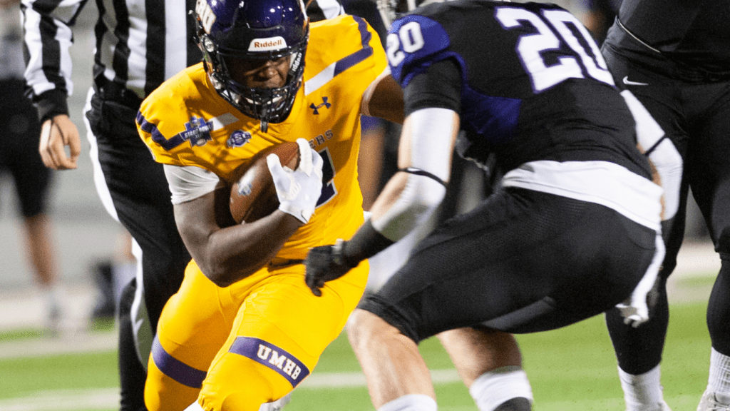 a football player is trying to catch the ball in the field