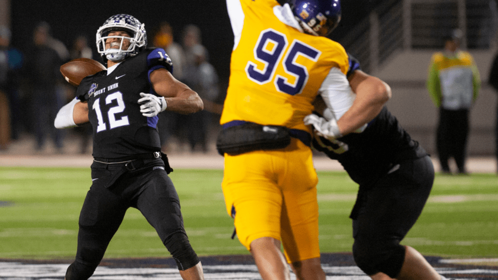 a football player throws the ball during a game