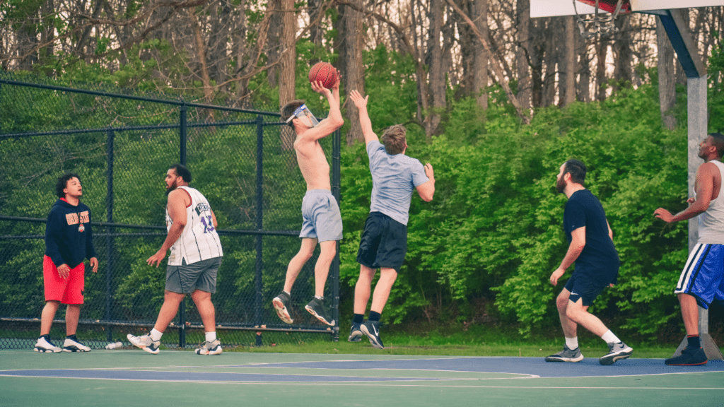 a group of people playing basketball 