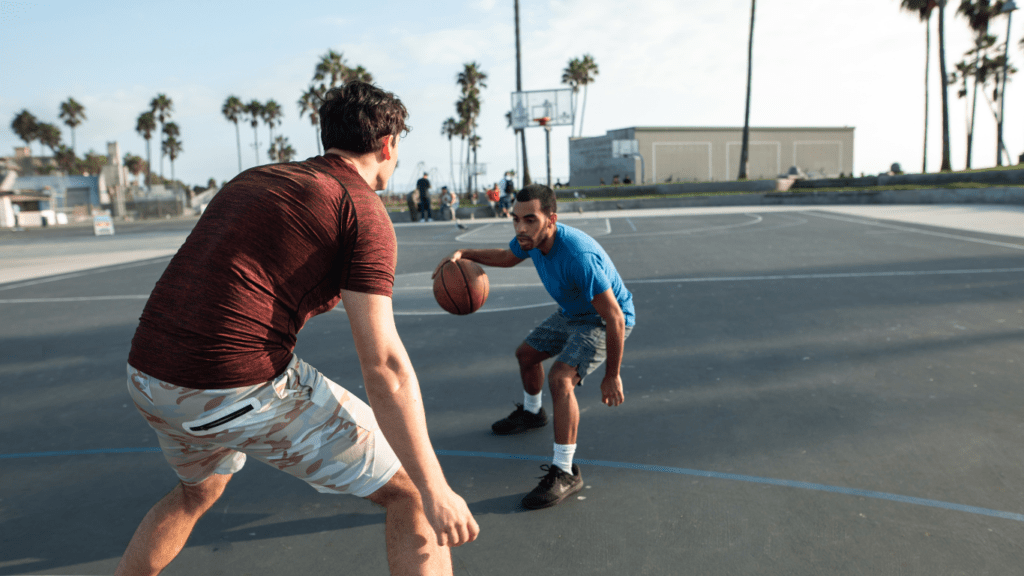 a person holding a basketball on a basketball court