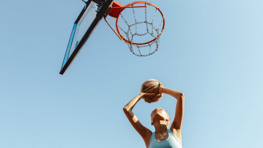 a person is jumping up to dunk a basketball