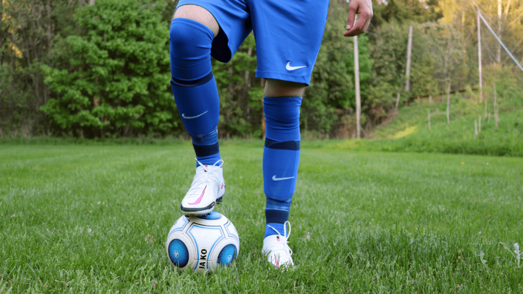 a person is standing on top of a soccer ball