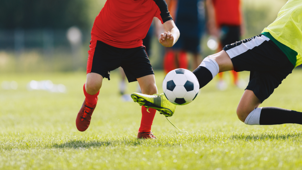 a person kicking a soccer ball