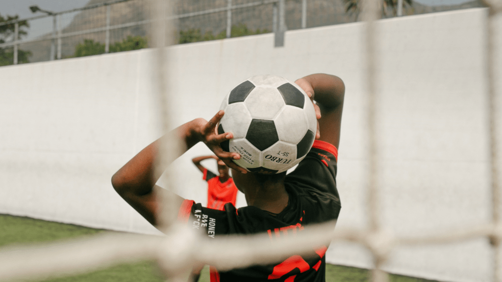 a soccer ball sits in front of a net