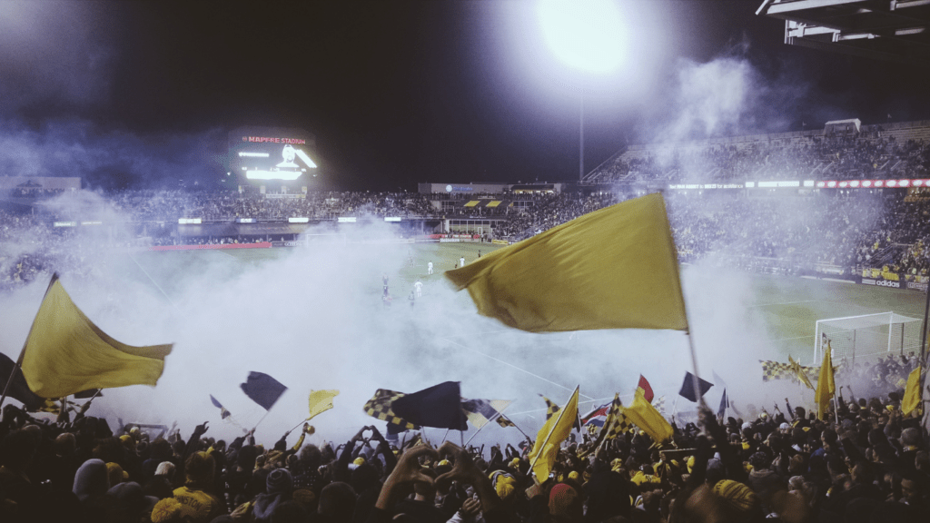 fans at a soccer game in an open stadium