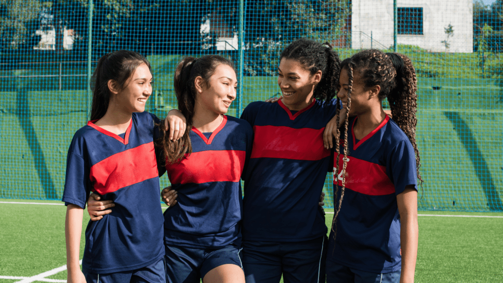 soccer players huddle together on the field