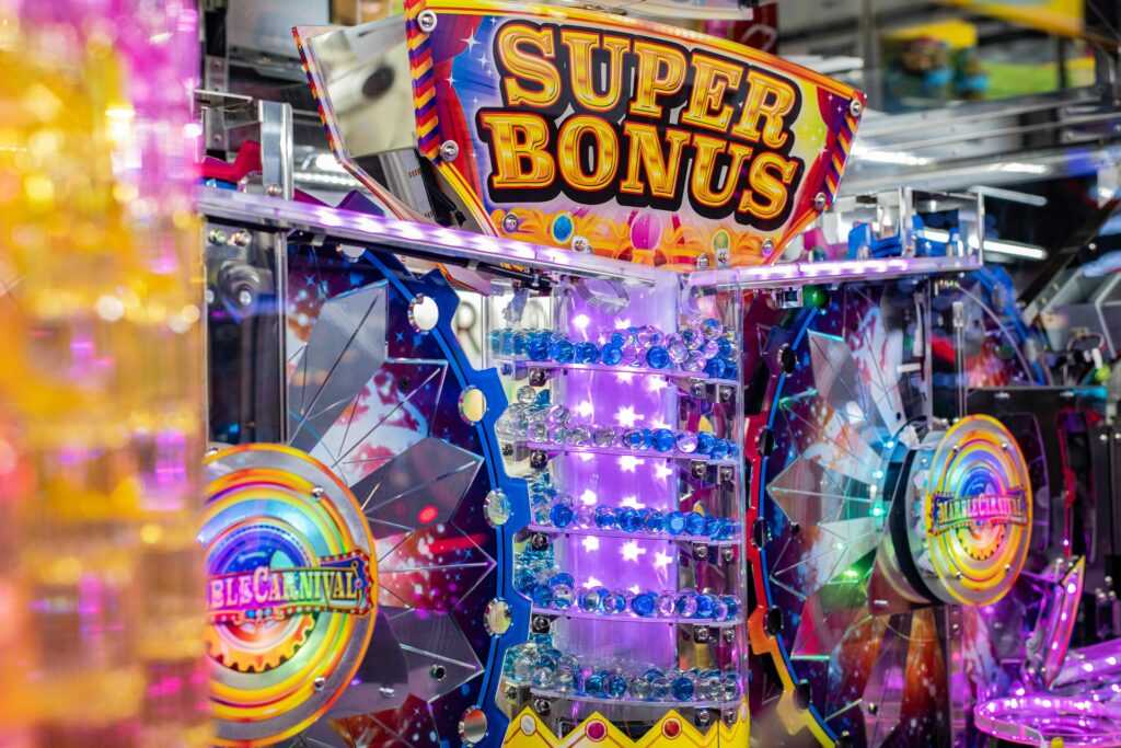 Colorful neon arcade machine featuring a 'Super Bonus' display with bright lights and playful design.